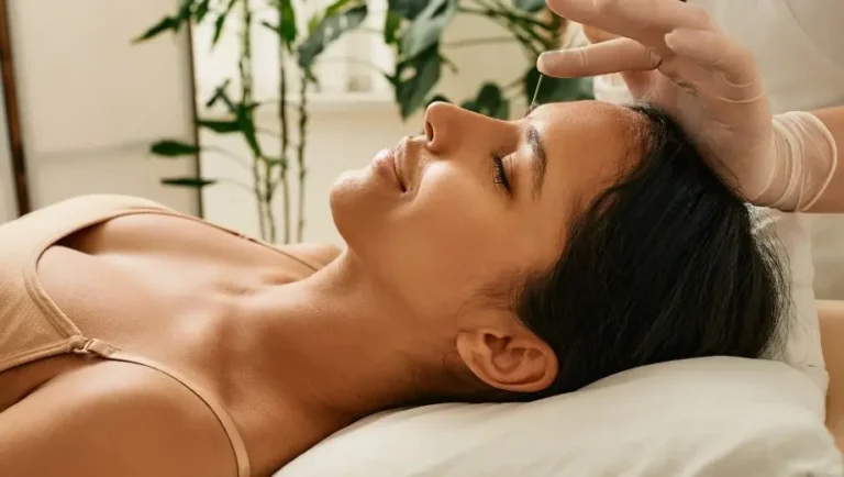 Woman enjoying acupuncture too enhance fertility outcomes
