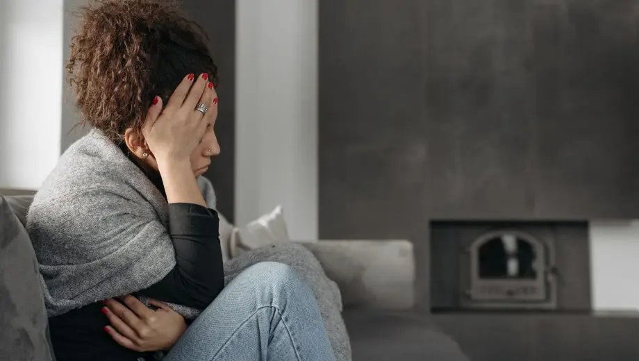 Woman suffering from a migraine during her period.