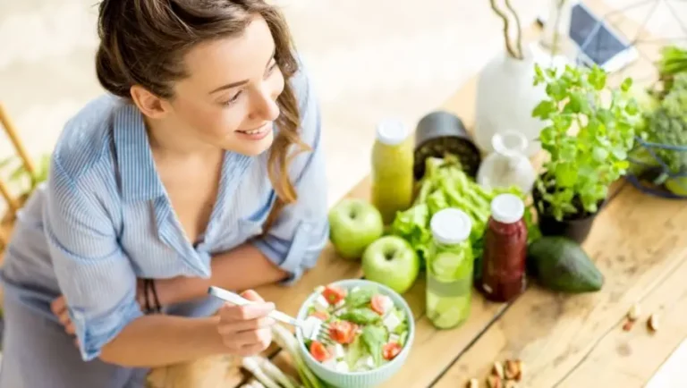 A woman eating healthy fiber rich foods to feed her beneficial got microbiome