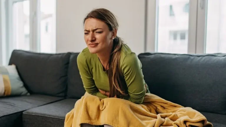 A woman suffering from stomach pain caused by a gut infection